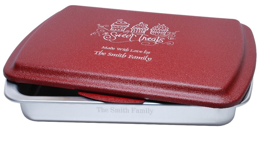A 9x13 cake pan with a cranberry lid, engraved Sweet Treats and Made With Love by The Smith Family, with the family name engraved on the side of the pan as well.